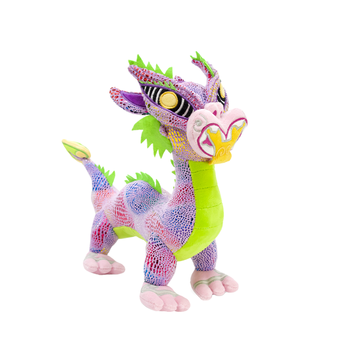 Colorful taniwha plush toy on a white background
